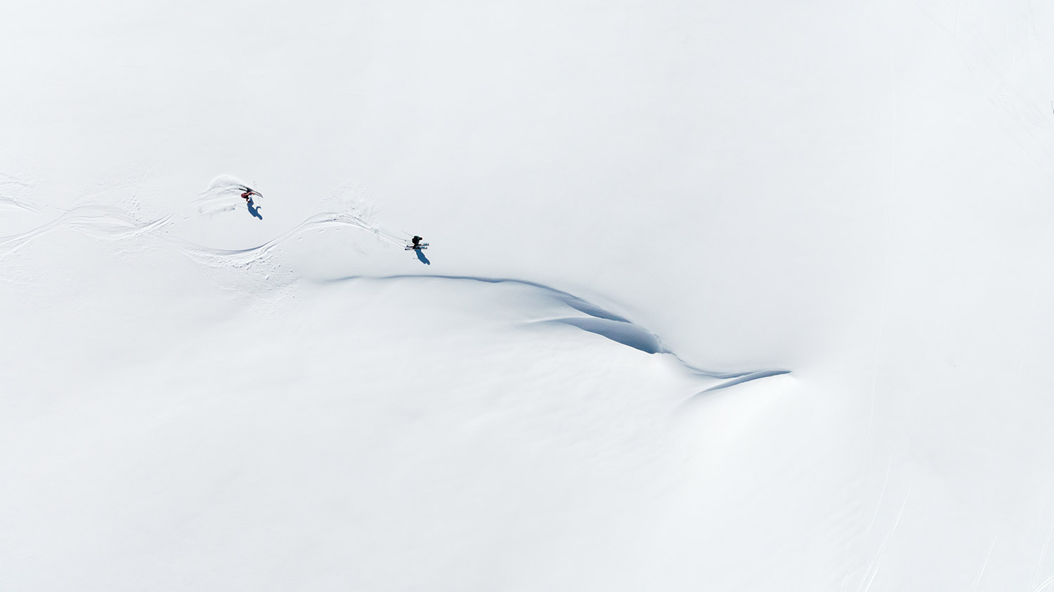 Bild Luftaufnahme von zwei Skifahrern bei der Abfahrt.