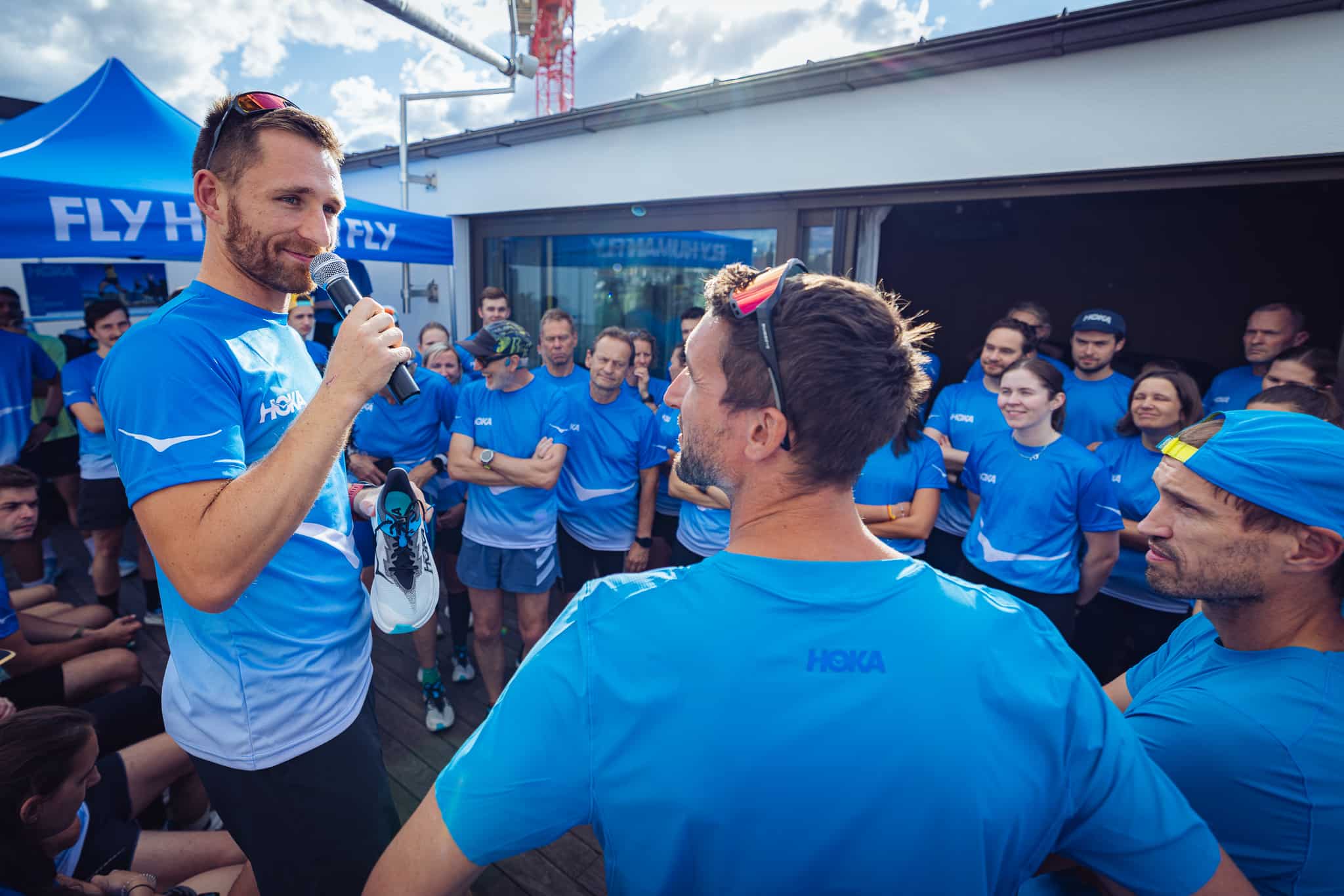 Mann mit Mikrofon spricht zu Community