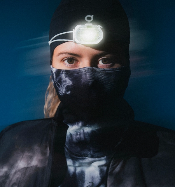 Frau mit Running-Outfit und Stirnlampe